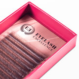 Pink box containing false eyelashes with 'Eyelash Excellence' branding.