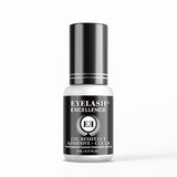 Eyelash adhesive bottle with black and white design on a white background