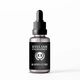 Eyelash serum bottle with dropper labeled 'Eyelash Excellence Rapid Cure' on a white background