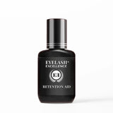 Black bottle of Eyelash Excellence Retention Aid on a white background