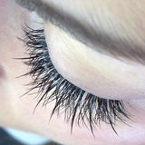 Close-up of an eye with long, dark spiked eyelashes