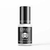 Eyelash extension glue bottle labeled 'Eyelash Excellence Topaz' on a white background