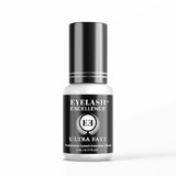 Eyelash extension glue bottle with black and white design on a white background